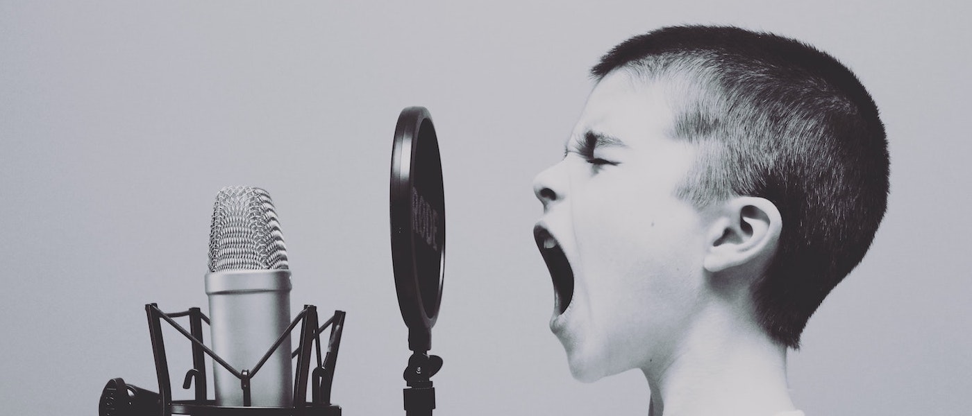 Foto: Kleiner Junge schreit in ein Mikrophon